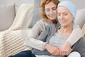 Woman comforting friend with cancer