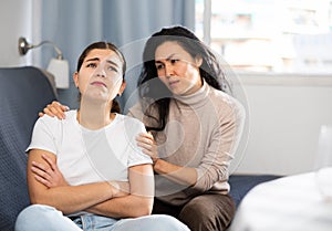 Woman comforting her depressed female friend