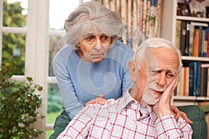 Woman Comforting Senior Man With Depression