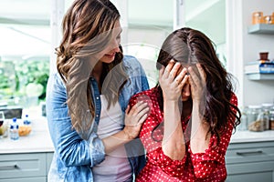 Woman comforting worried friend