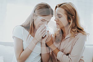 Woman Comforts Unhappy Teenage Daughter at Home