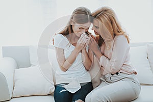 Woman Comforts Unhappy Teenage Daughter at Home