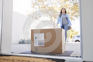 Woman Coming Back To Home Delivery In Cardboard Box Outside Front Door