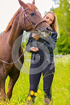 Woman communicate with her beautilful arabian horse friend in the field