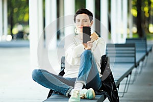 A woman communicates on a smartphone in the park