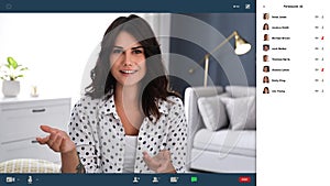 Woman communicating with coworkers from home using video chat, view through camera