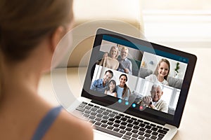 Woman communicating with family using laptop and videoconference application photo