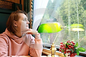 Woman in compartment of vintage train carriage