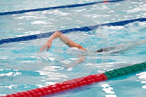 Woman competes in freestyle swimming in a swimming pool