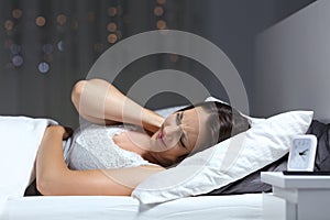 Woman suffering fibromyalgia in the night in the bed photo