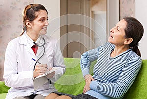 Woman complaining to doctor about stitch in side
