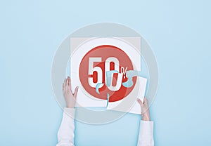 Woman completing a puzzle with a 50% off discount icon