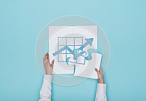 Woman completing a puzzle with a graph icon photo