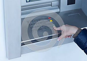 Woman completing a transaction on an ATM