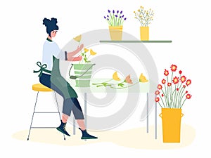 Woman compose bouquet on table. Forist shop or store.