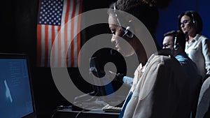 Woman at computer in flight control center