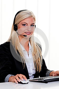 Woman at computer with headset and Hotline