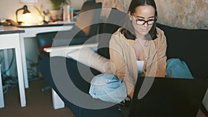 Woman, computer on sofa and thinking of work from home research, copywriting career and planning online. Young