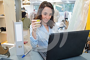 Woman with computer in store