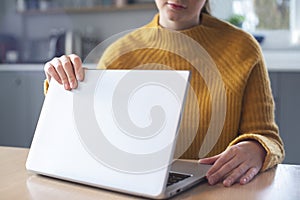 Woman Concerned About Excessive Use Of Internet Closing Lid Of Laptop Computer