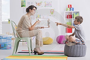 Woman conducting child`s psychological test