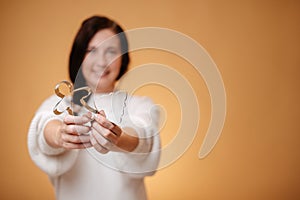 Woman confectioner blurred holding metal cookie cutter.