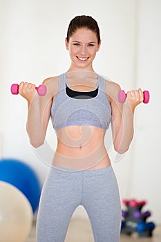 Woman, confident or portrait with dumbbells in gym, health wellness or fitness for weight loss with exercise. Young