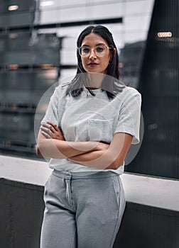 Woman, confident and portrait of worker on balcony at office outdoor in city to relax for break. Employee, glasses and