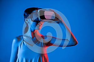 Woman confidently pose while look into virtual area of metaverse. Hallucination.