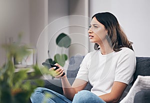 Woman confused watching tv, streaming with remote control and relax at home, thinking or vision problem with squint