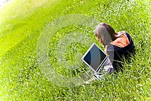 Woman connected on the grass