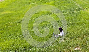 Woman connected on the grass