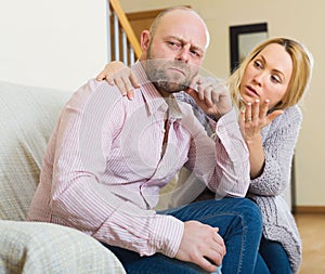 Woman consoling sad men photo