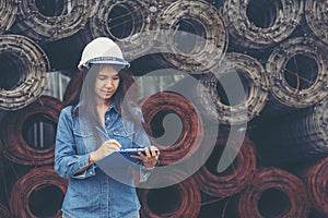 Woman construction engineer wear safety white hard hat at construction site industry worker. Female engineer worker civil