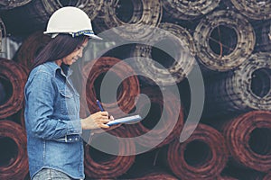 Woman construction engineer wear safety white hard hat at construction site industry worker. Female engineer worker civil