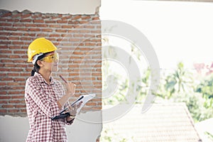 Woman construction engineer wear safety white hard hat at construction site industry worker. Female engineer worker civil