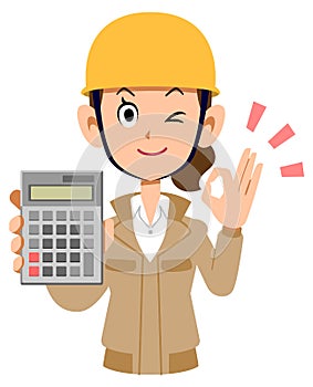 A woman at a construction site holding a calculator and giving an OK sign