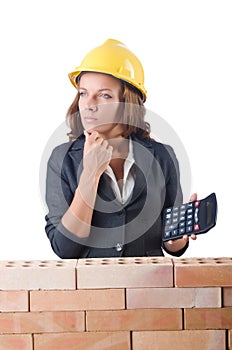 Woman construction worker with calculator photo