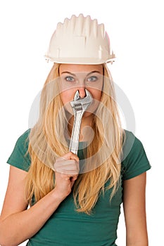 Woman with constructor helmet and tools gesturing stuffy nose