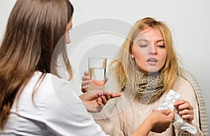 Woman consult with doctor. Girl in scarf examined by doctor. Cold and flu remedies. Doctor communicate with patient