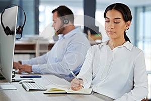 Woman, consultant and book in call center office, notes and schedule for customer service or telemarketing in coworking