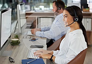 Woman, consultant and headset in call center office, typing and customer service or telemarketing in coworking space