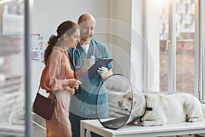 Woman Consulting Veterinarian at Clinic