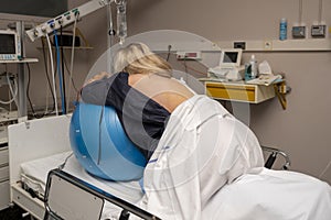 Woman during contractions on a fitness ball Parturition hospital