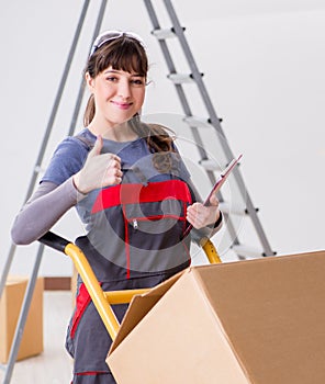 Woman contractor moving boxes in relocation concept