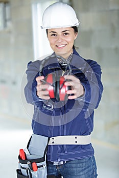 woman contractor worker with noise cancelling earmuffs