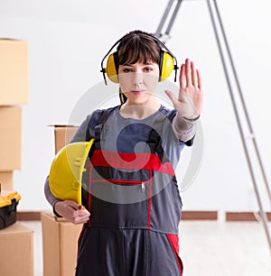 Woman contractor worker with noise cancelling headphones