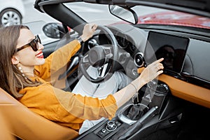 Woman controlling car with a digital dashboard