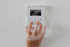 The woman controls the temperature in the house. Air conditioning and heating system in a private house