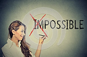 Woman converting the word impossible to possible photo